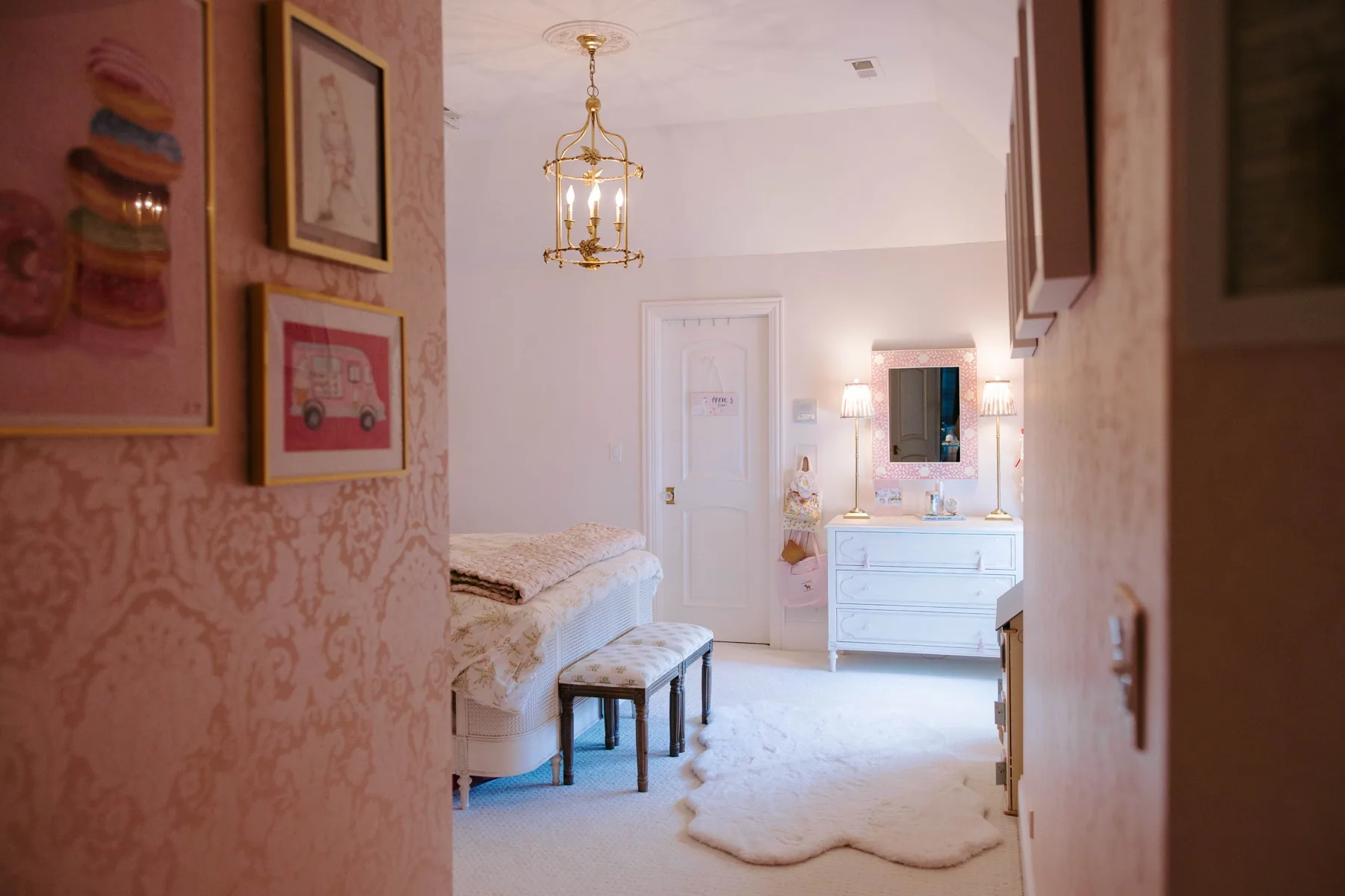 Softly layered pink bedroom with patterned textiles and collected details