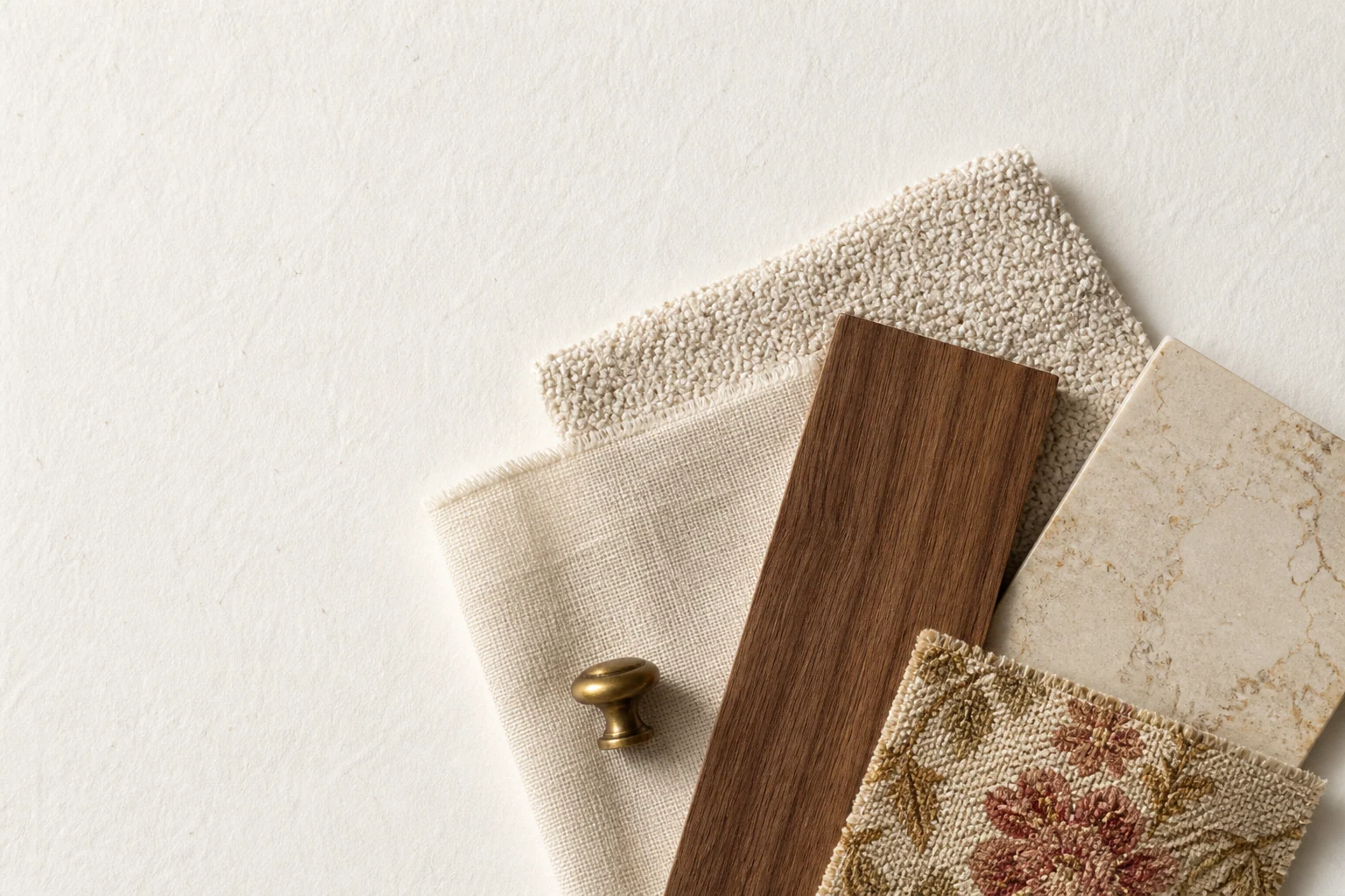 A curated flat lay of warm interior materials and finishes